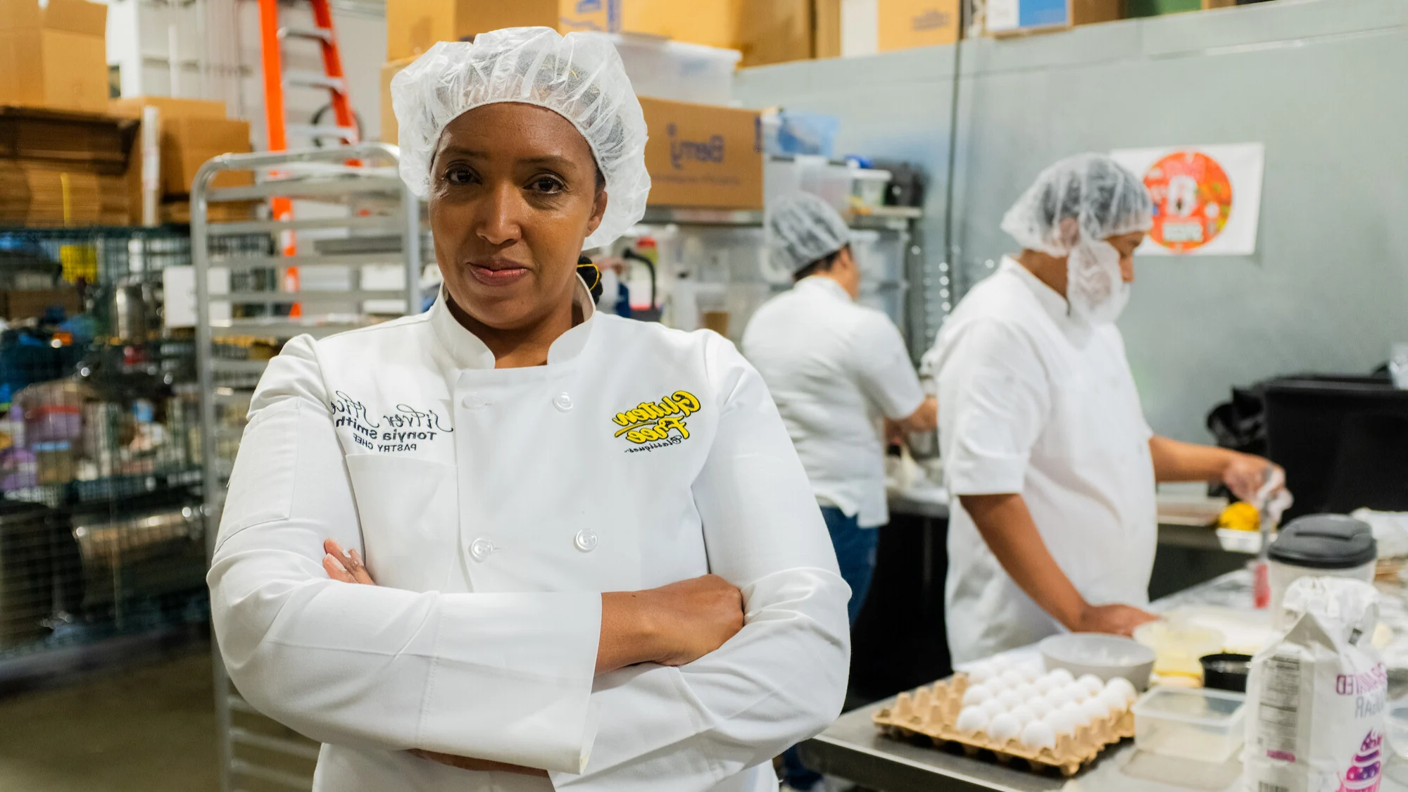 female owner of silverslice bakery posing in her kitchen