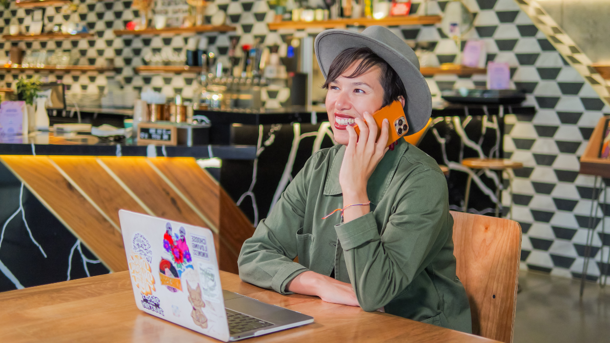 Owner of Mothership Coffee on the Phone in a cafe